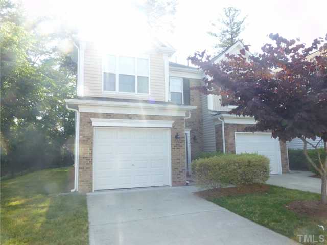 7241 Racine Way Raleigh, NC 27690 - Photo 21 of 25 a front view of a house with yard and trees