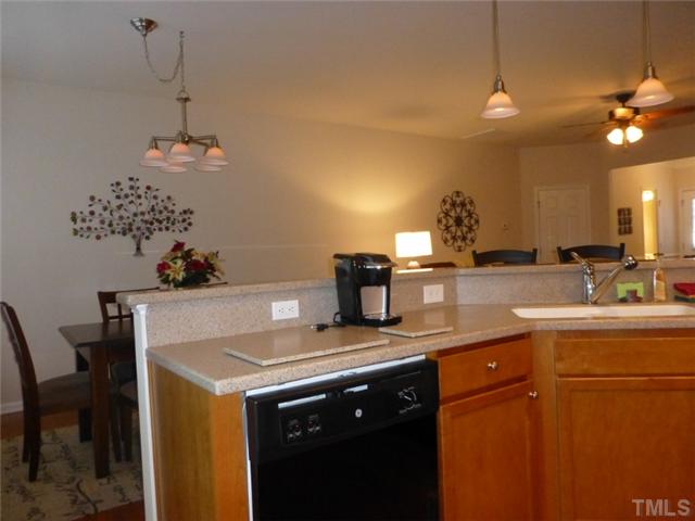 7241 Racine Way Raleigh, NC 27690 - Photo 10 of 25 a kitchen with a sink a counter space and cabinets