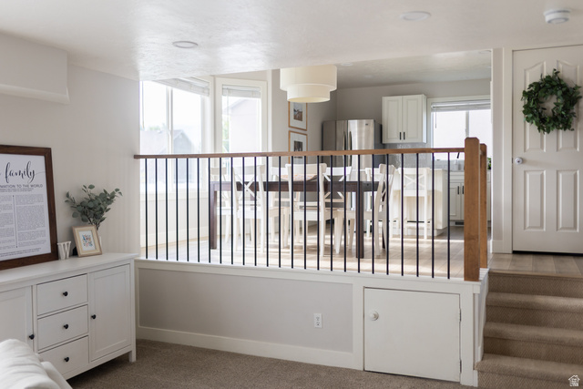 1204 North 3020th Street West Provo, UT 84601 - Photo 21 of 35 Multi-level interior featuring a wood-finish handrail with black iron balusters, recessed lighting, and a neutral color palette
