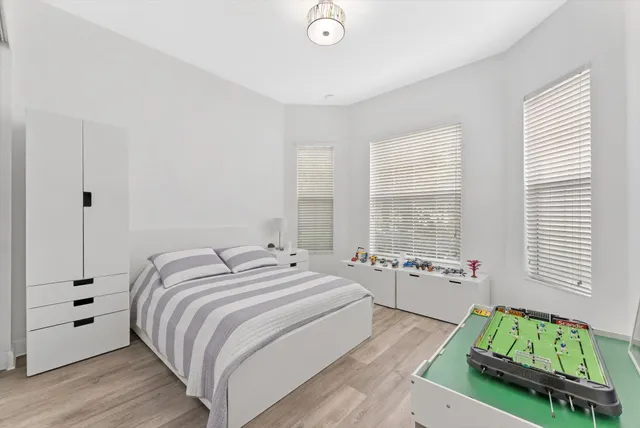 a bedroom with bed and a window