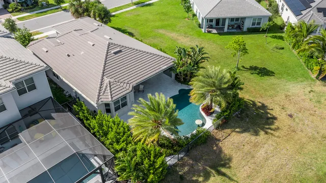 an aerial view of a house with swimming pool and porch with furniture