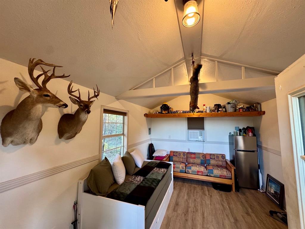 16811 County Road 107 Mingus, TX 76463 - Photo 12 of 38 a bedroom with furniture and a wooden floor