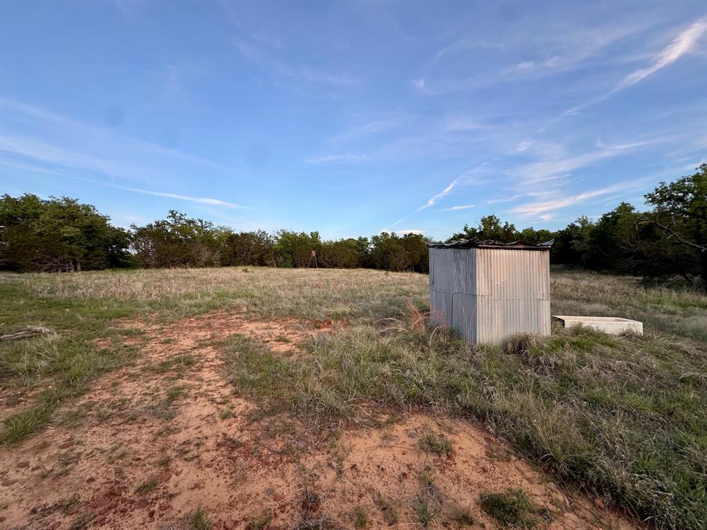 16811 County Road 107 Mingus, TX 76463 - Photo 33 of 38 a view of a lake with a building in the background