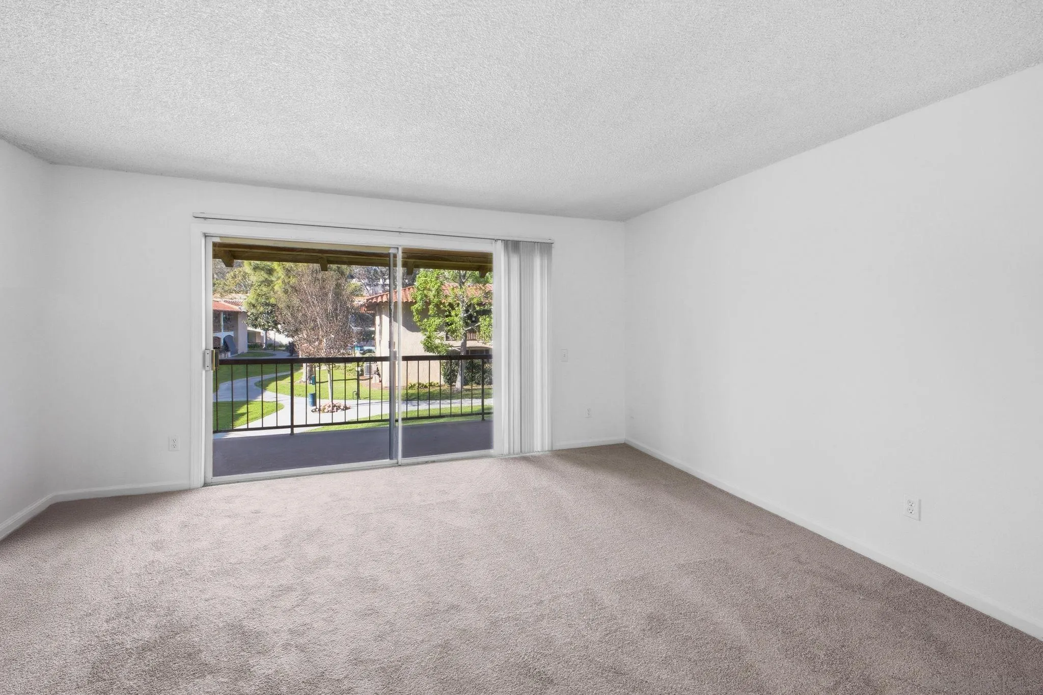 6019 Rancho Mission Road, Unit 204 San Diego, CA 92108 - Photo 7 of 38 Spacious living room & private balcony overlooking courtyard