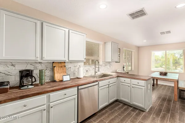 a kitchen with sink cabinets and window