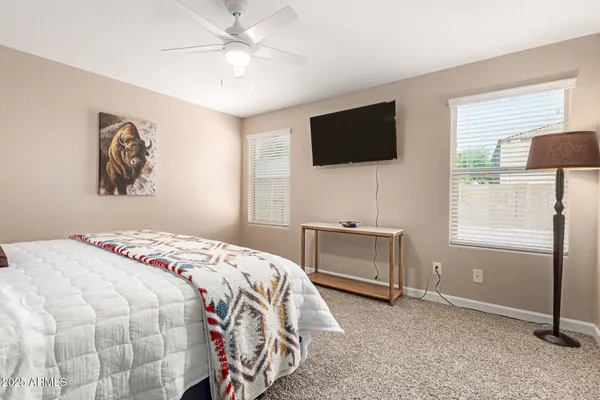 a bedroom with a bed and a flat screen tv