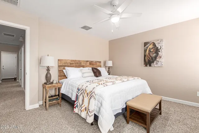 a bedroom with a bed and a chandelier