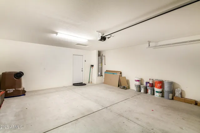 an empty room with a ceiling fan and a bathroom