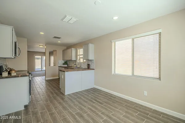 a kitchen with white cabinets