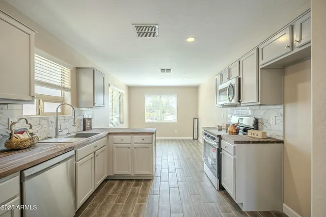 a stove top oven sitting inside of a kitchen