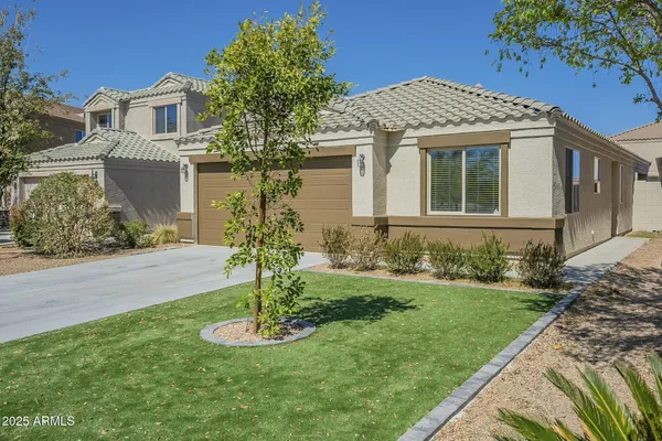 a front view of a house with a yard