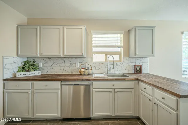 an empty room with a ceiling fan and carpet