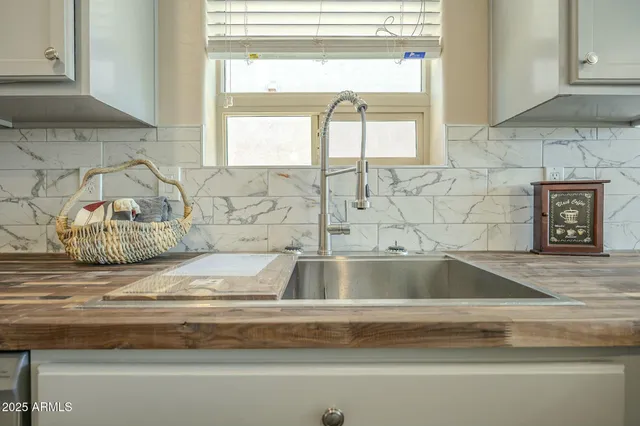 an empty room with a ceiling fan and carpet