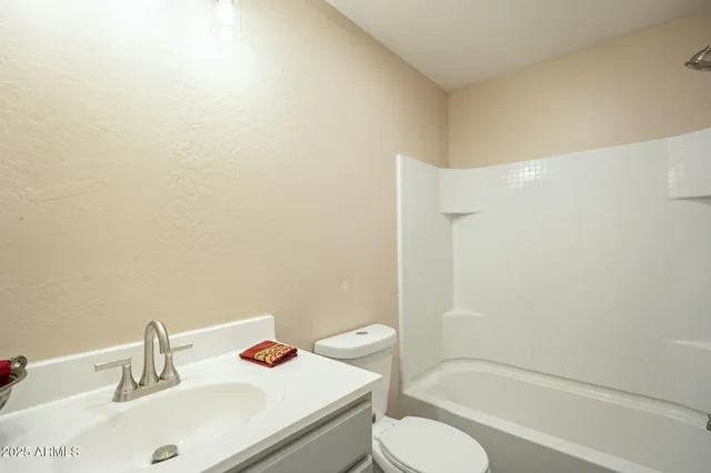 a bathroom with a tub and shower