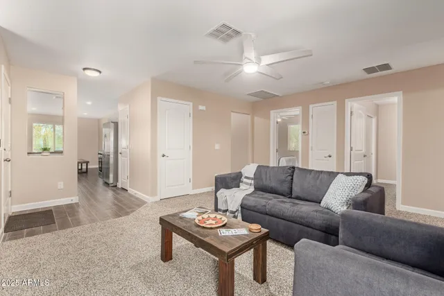 a living room with furniture and a wooden floor