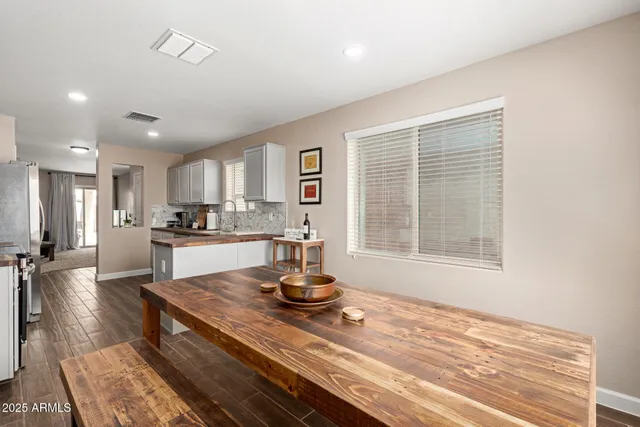 a kitchen with a refrigerator and a stove top oven