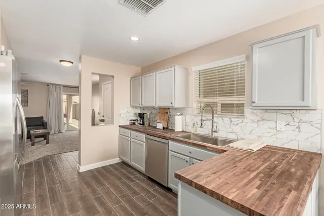 a kitchen with granite countertop a sink stove and cabinets