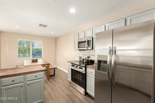 a kitchen with a refrigerator and a sink