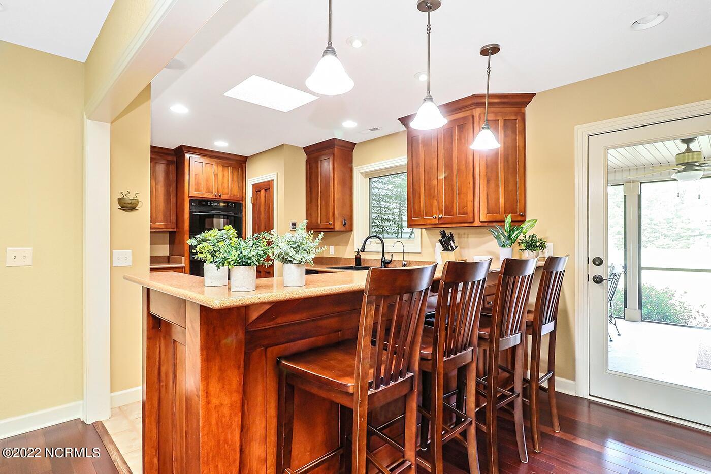 1079 Tulls Creek Road Moyock, NC 27958 - Photo 19 of 59 Eat in Kitchen boasts a snack bar, walk in pantry, recessed lighting, large dining area, solid surface counters, and tile flooring.