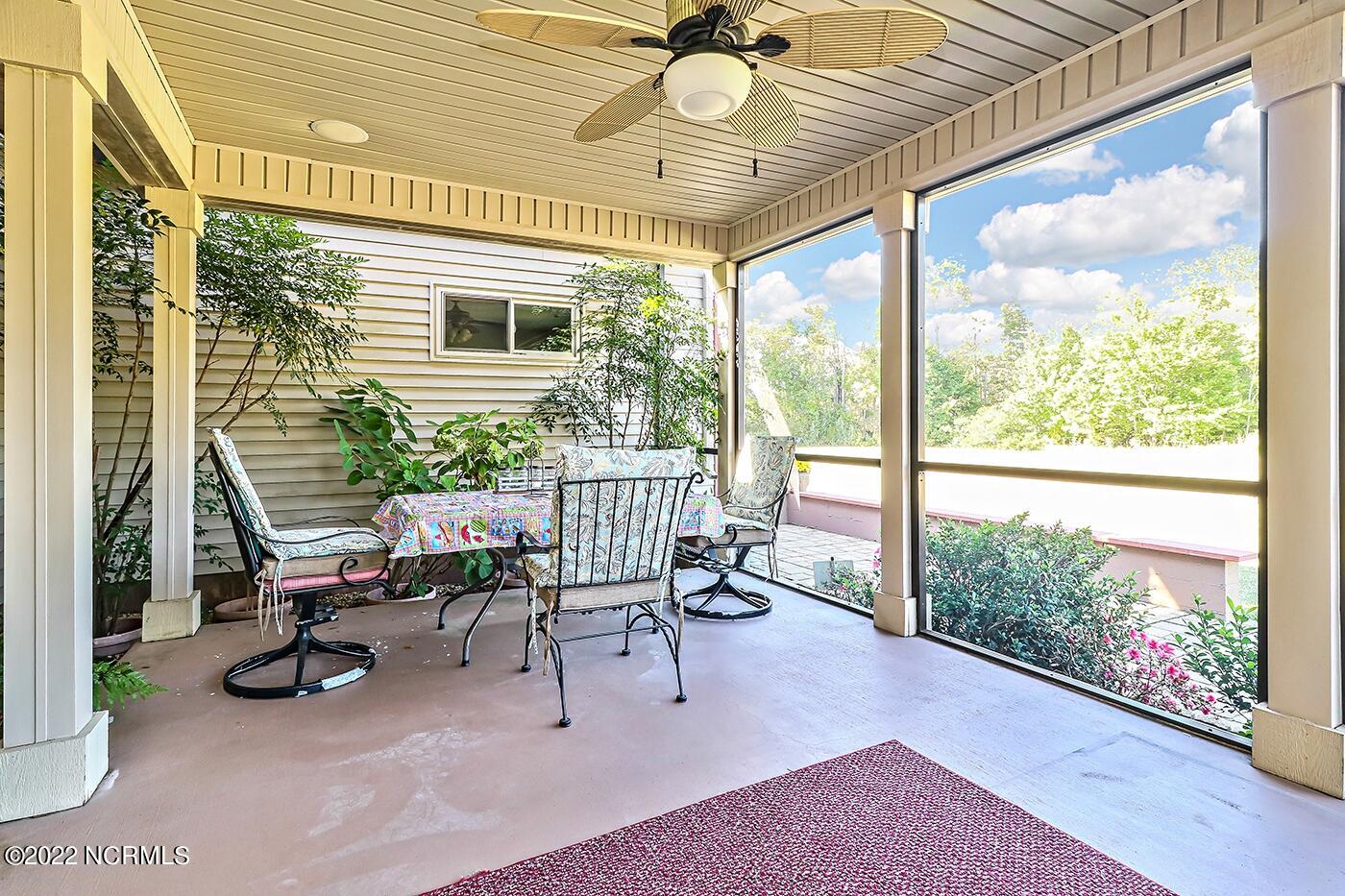 1079 Tulls Creek Road Moyock, NC 27958 - Photo 29 of 59 Screened Porch and Patio is located just off the Eat in Kitchen and is the perfect place to enjoy the private and serene country setting.