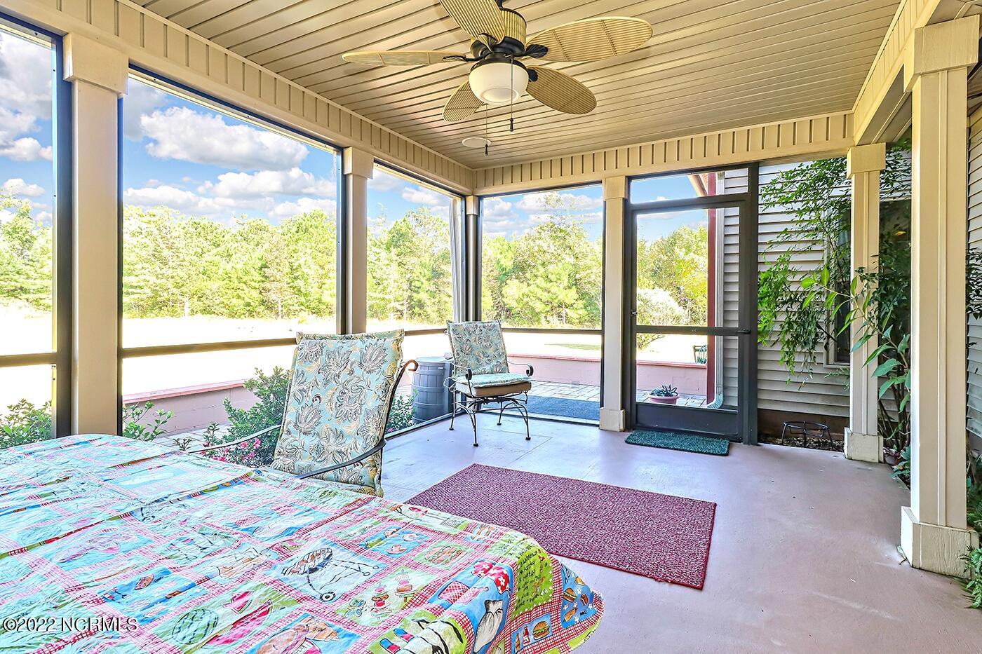 1079 Tulls Creek Road Moyock, NC 27958 - Photo 30 of 59 Located just off the Eat in Kitchen, this Screened Porch and Patio is spacious and private. Enjoy the tranquil setting!