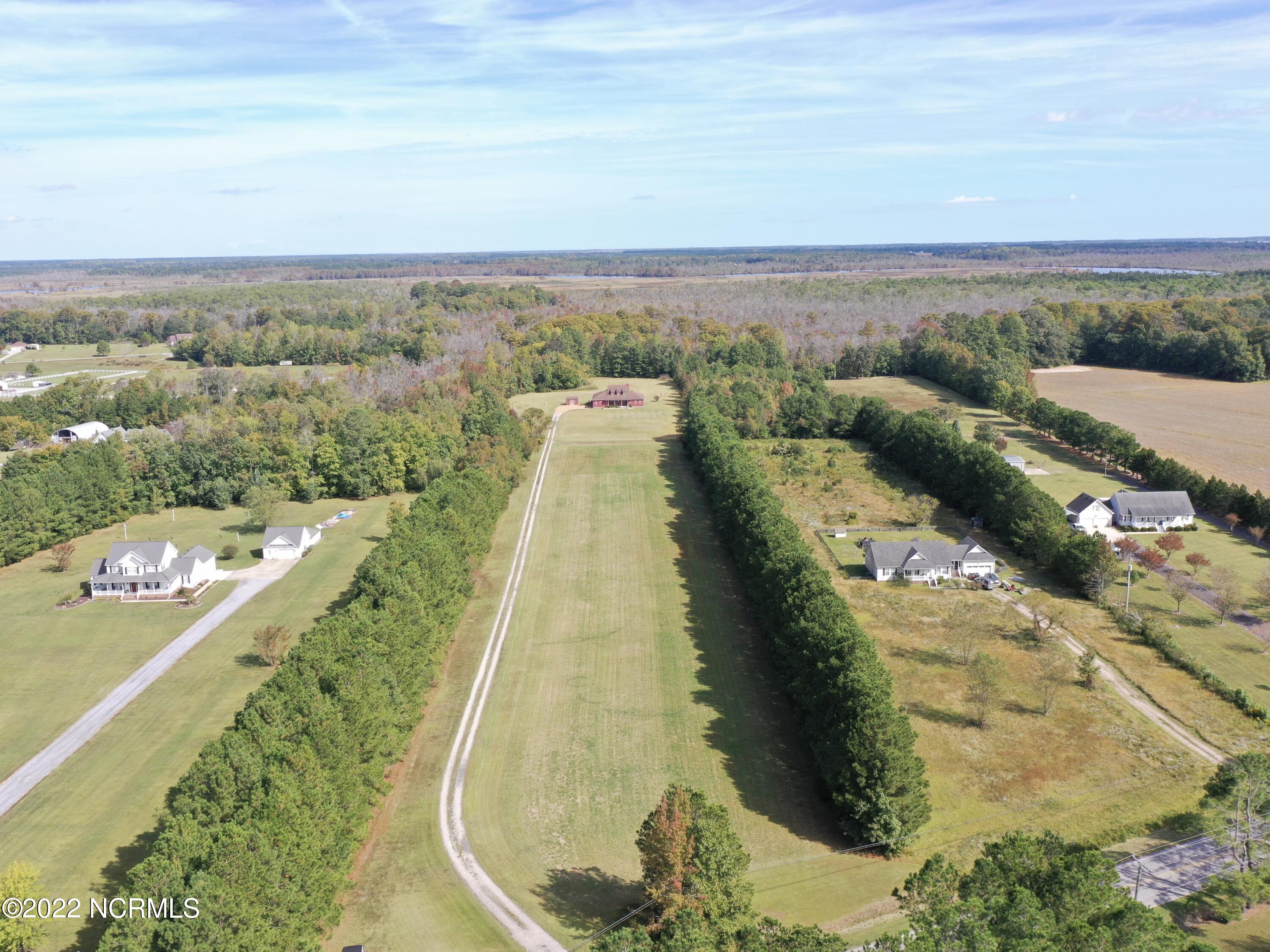 1079 Tulls Creek Road Moyock, NC 27958 - Photo 3 of 59 Situated on 10 acres in Currituck County and within 10 minutes to the VA border. Enjoy the private and serene country setting!