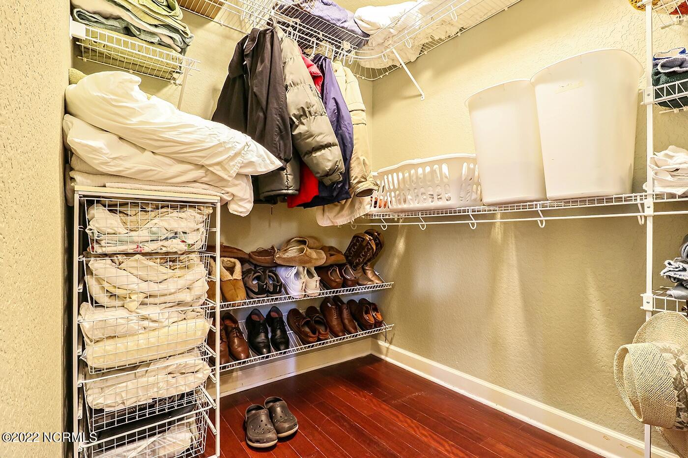 1079 Tulls Creek Road Moyock, NC 27958 - Photo 36 of 59 Large Walk in Closet in First Floor Owner’s Suite features hardwood flooring.