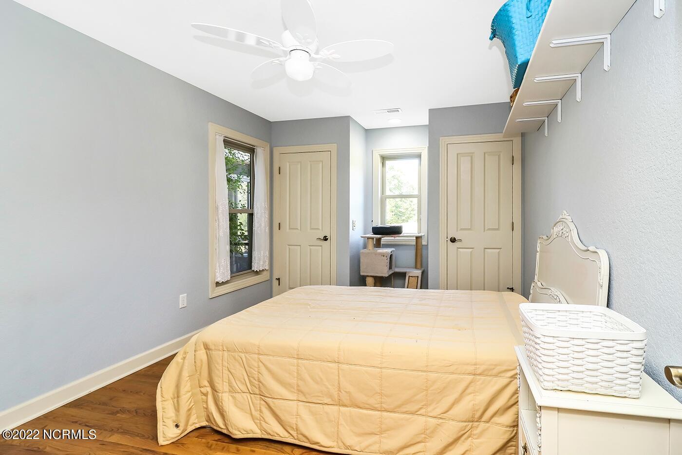 1079 Tulls Creek Road Moyock, NC 27958 - Photo 37 of 59 Secondary Bedroom with overhead lighting, laminate wood flooring and double closets. The secondary bedrooms share a full bathroom on the first floor.