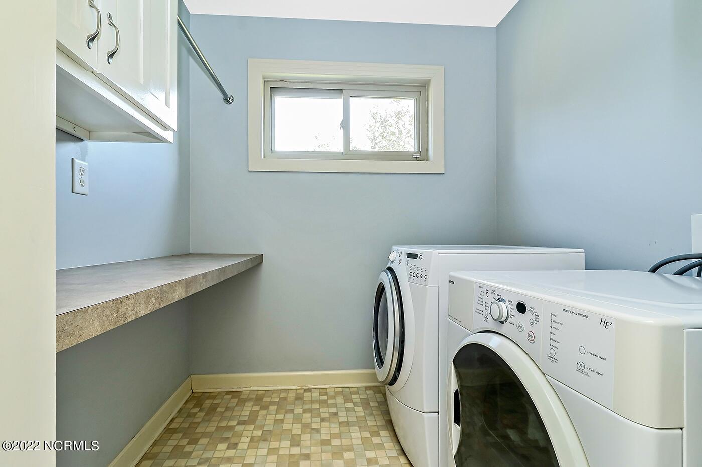 1079 Tulls Creek Road Moyock, NC 27958 - Photo 42 of 59 Located on the first floor is a large Laundry Room wtih upper cabinets and a folding area.