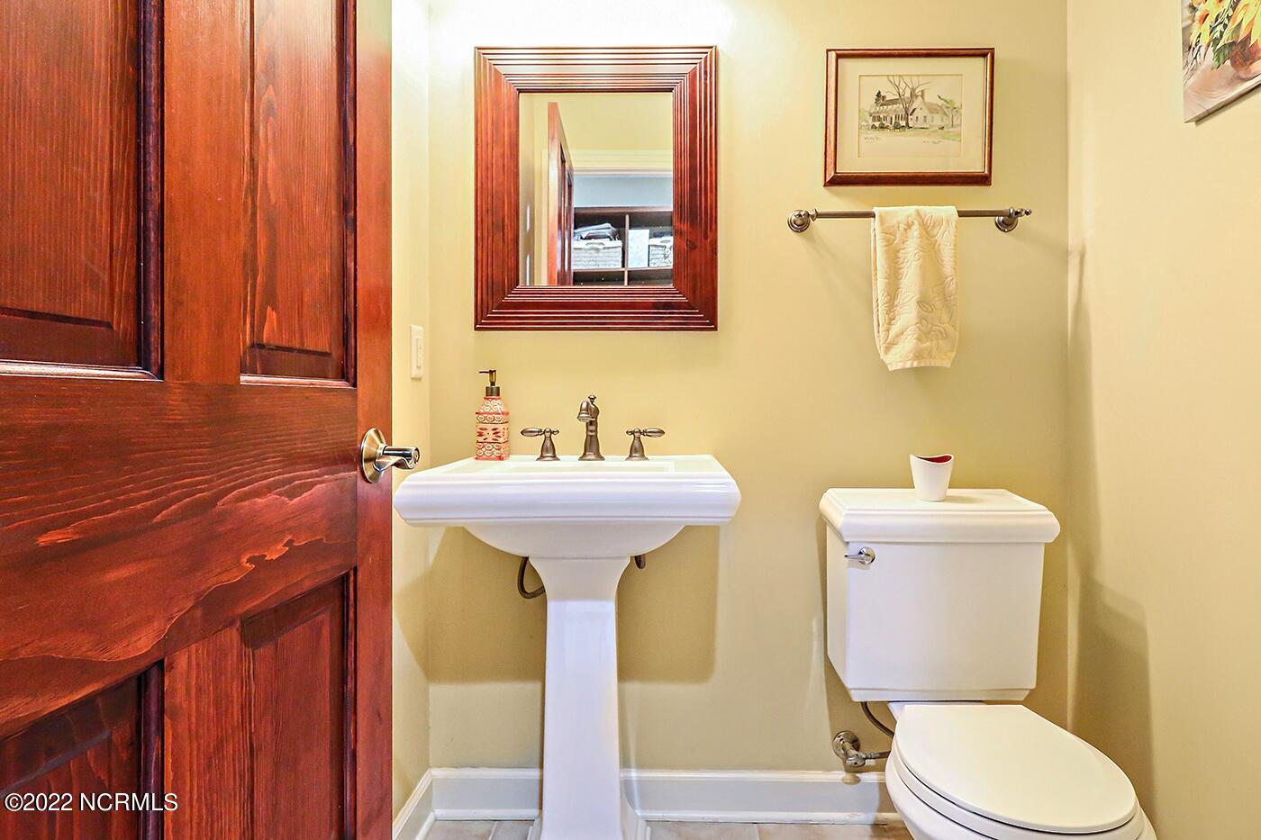 1079 Tulls Creek Road Moyock, NC 27958 - Photo 44 of 59 Half Bath located on the first floor and serves guests.