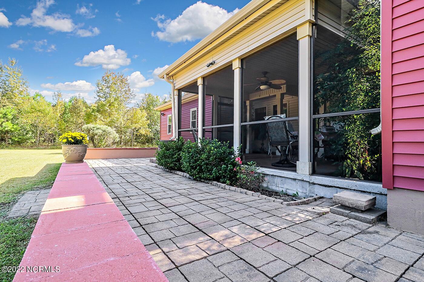 1079 Tulls Creek Road Moyock, NC 27958 - Photo 54 of 59 Screened Porch and Patio to enjoy the private and serene country setting.