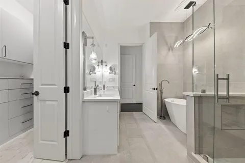 a bathroom with a double vanity sink toilet and shower