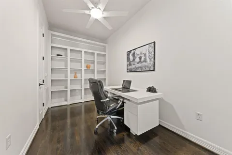 a view of a workspace with furniture and wooden floor
