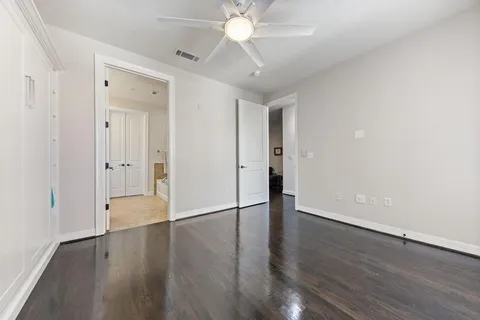 a view of an empty room with wooden floor