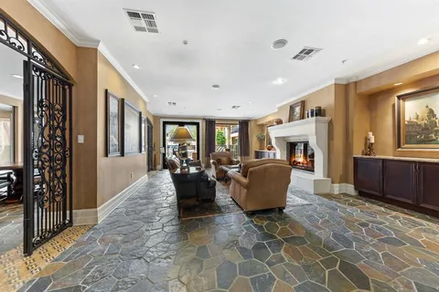 a living room with furniture a large window and a fireplace