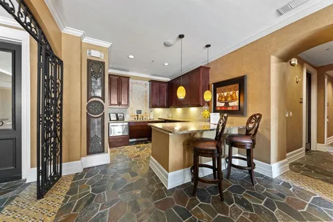 a kitchen with stainless steel appliances granite countertop sink cabinets and wooden floor