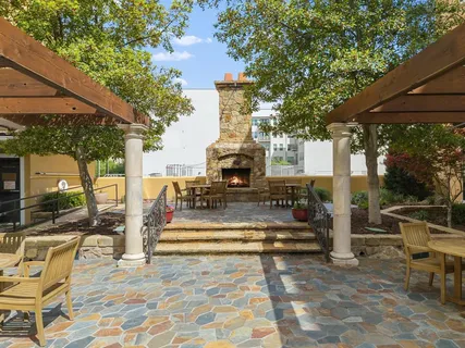 a view of a patio with couches table and chairs and potted plants