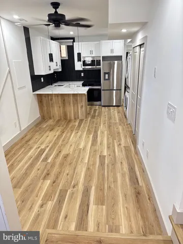 a view of a living room with a wooden floor