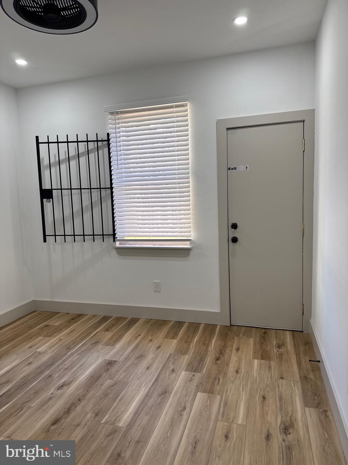 2031 North 19th Street, Unit A Philadelphia, PA 19121 - Photo 13 of 17 a view of an empty room with wooden floor and a window