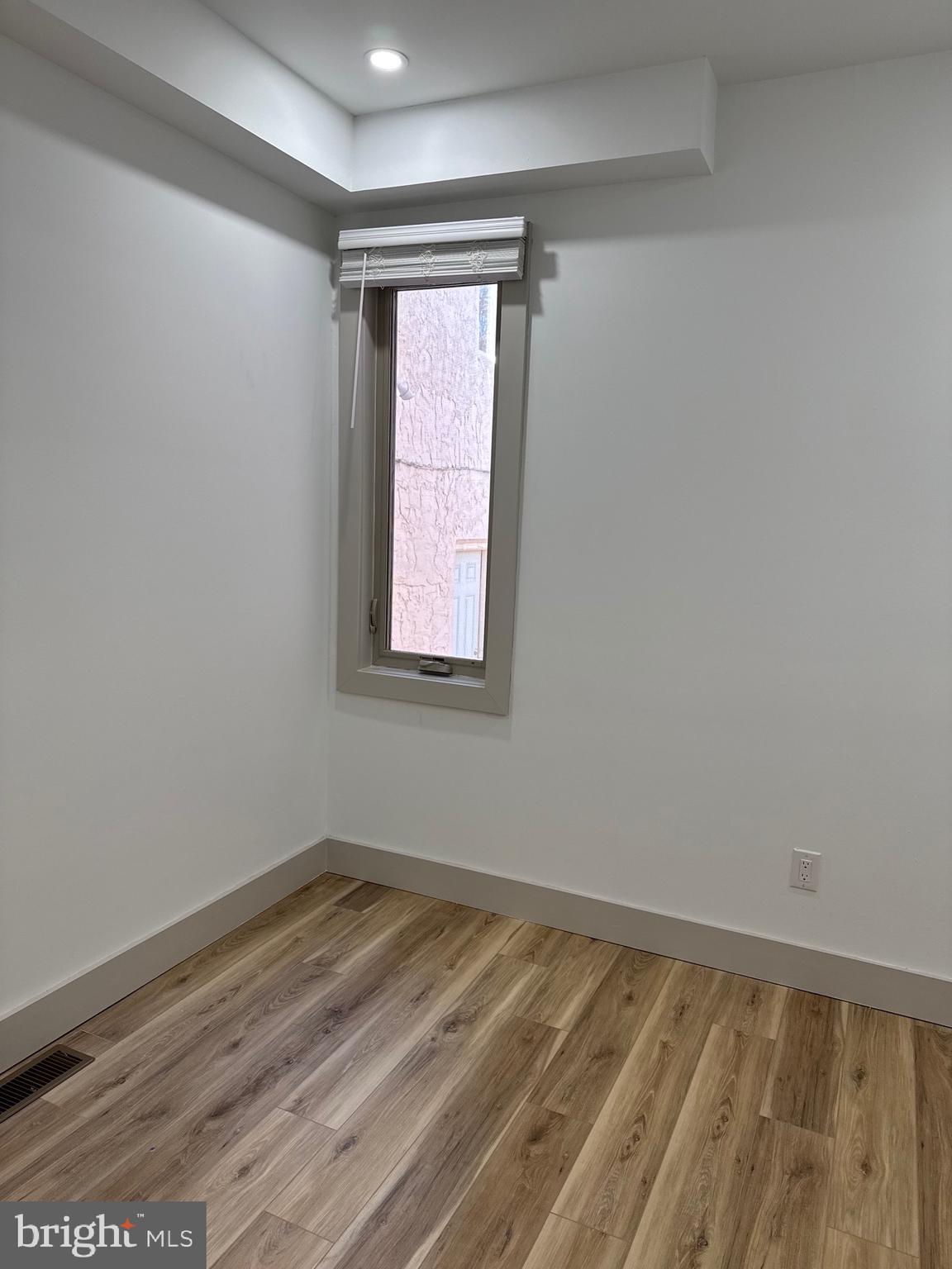2031 North 19th Street, Unit A Philadelphia, PA 19121 - Photo 10 of 17 a view of an empty room with wooden floor and a window