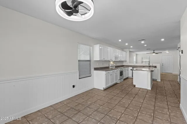 a kitchen with a white cabinets and white appliances