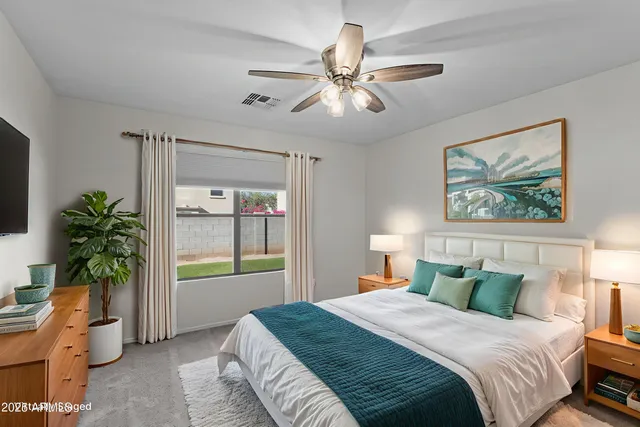 a bedroom with a large bed and a window