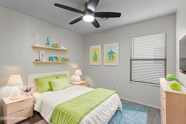 a bedroom with a bed and a window