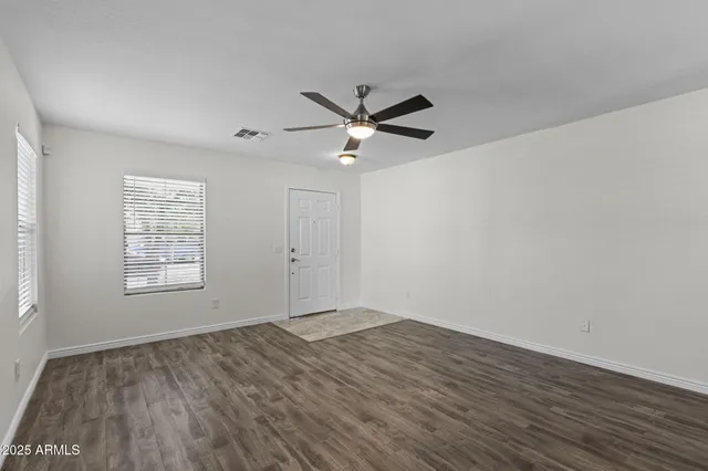 wooden floor in an empty room with a window