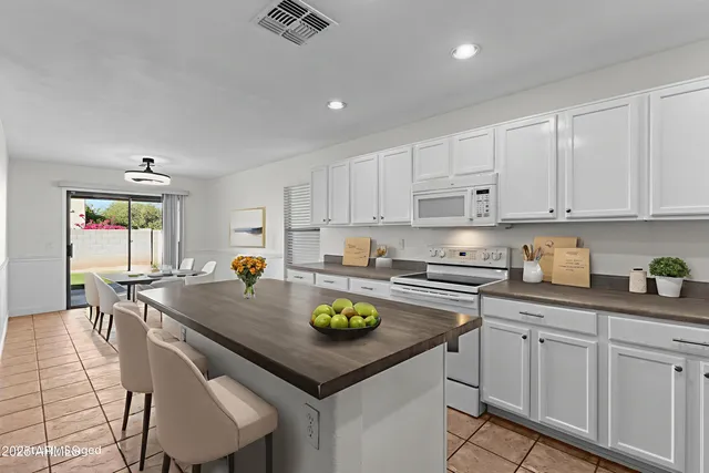 a kitchen with sink white cabinets and appliances