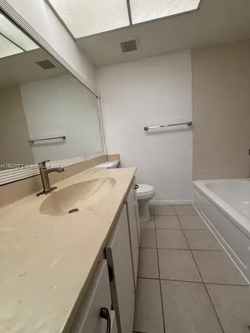 a bathroom with a bathtub and toilet