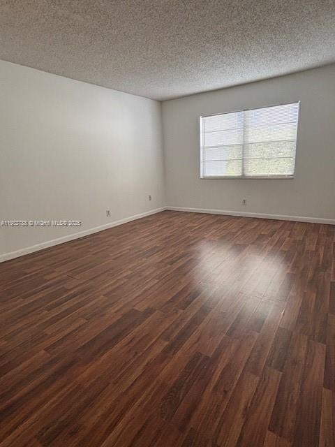 9235 Southwest 8th Street, Unit 510 Boca Raton, FL 33428 - Photo 16 of 23 an empty room with wooden floor and windows