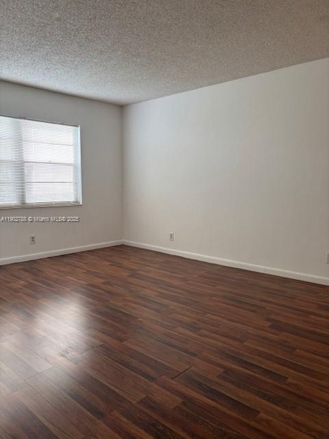 9235 Southwest 8th Street, Unit 510 Boca Raton, FL 33428 - Photo 17 of 23 an empty room with wooden floor and windows