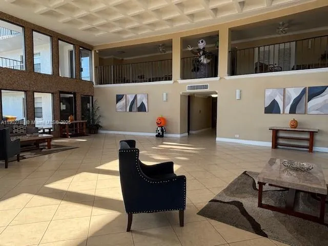 a view of a hallway with a dining table and chairs