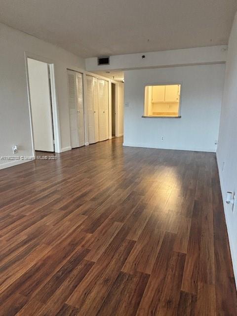 9235 Southwest 8th Street, Unit 510 Boca Raton, FL 33428 - Photo 5 of 23 a view of empty room with wooden floor and fan